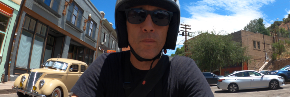 Sterling Noren riding vintage motorcycle in Bisbee Arizona