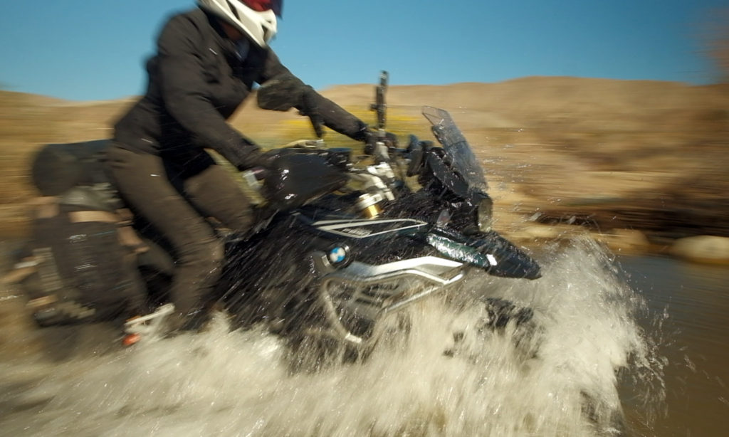 Motorcyclist crossing a stream