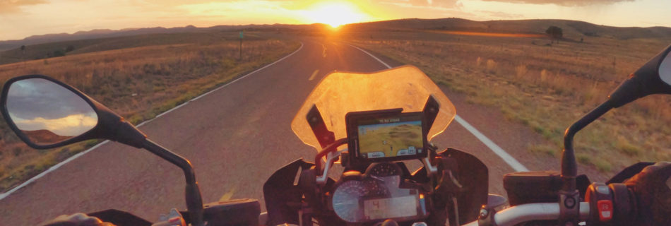 Riding solo into the sunset on a motorcycle in New Mexico