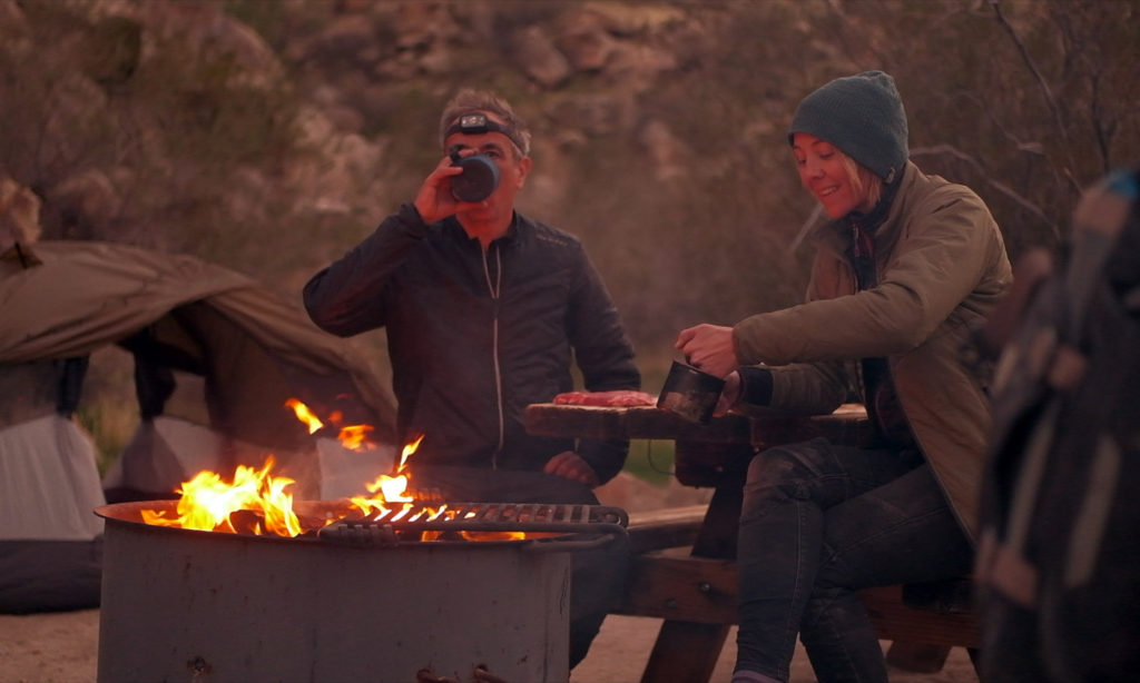 two people at a campfire