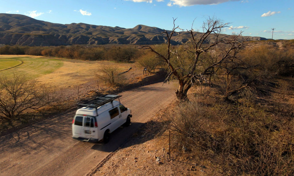 Van driving down Cascabel Road in Arizona desert.