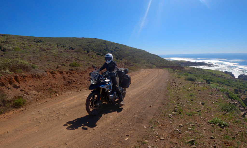 Motorcycle and ocean on dirt road coast of Baja California