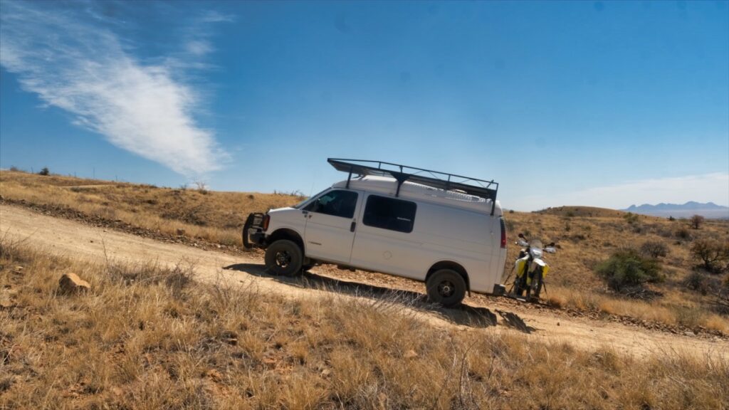 Chevrolet 4x4 Quigley van with motorcycle in Santa Rita Mountains Arizona