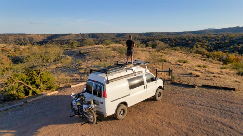 Rooftop deck on Chevrolet 4x4 Quigley van with motorcycle in Santa Rita Mountains Arizona