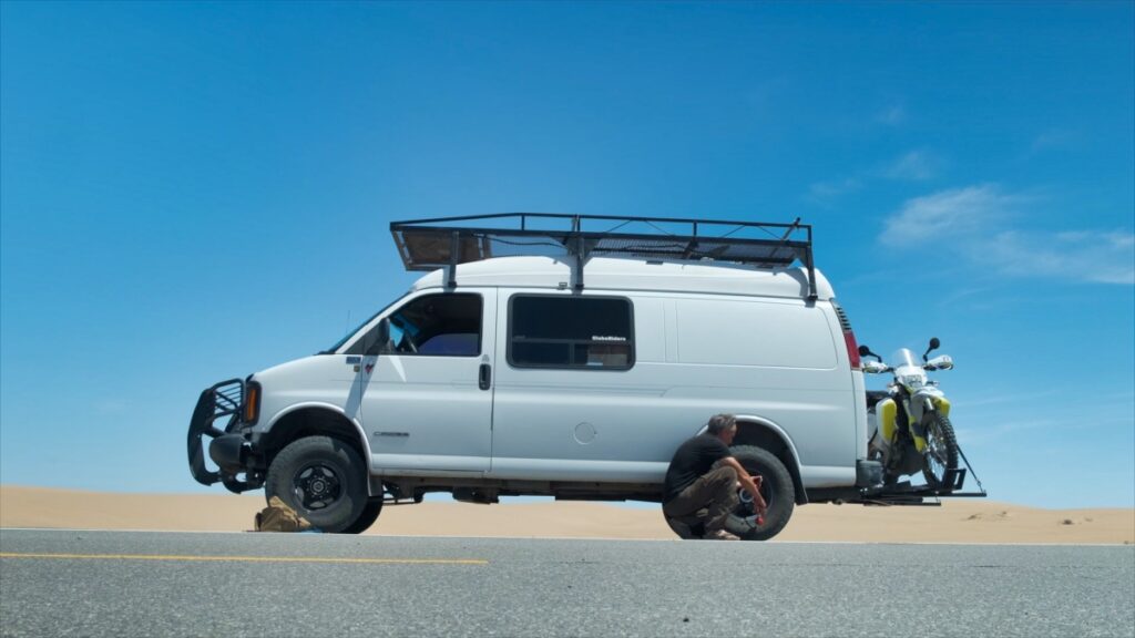 Chevrolet Express Quigley 4x4 van with motorcycle in Imperial Sand Dunes