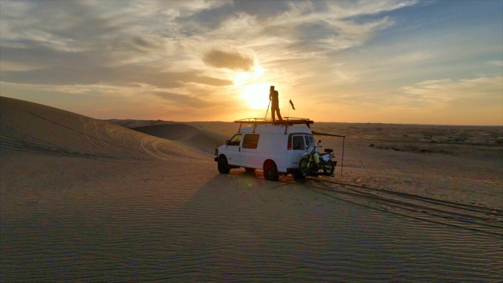 Filmmaker on Chevrolet Express Quigley 4x4 van Imperial Sand Dunes