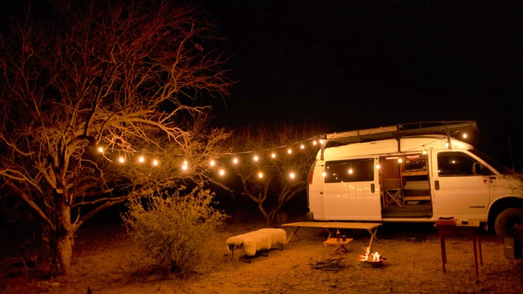 Chevrolet Quigley 4x4 van with string lights overland camping