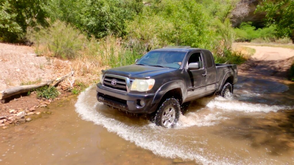 Tacoma truck driving through creek in Airivaipa Canyon