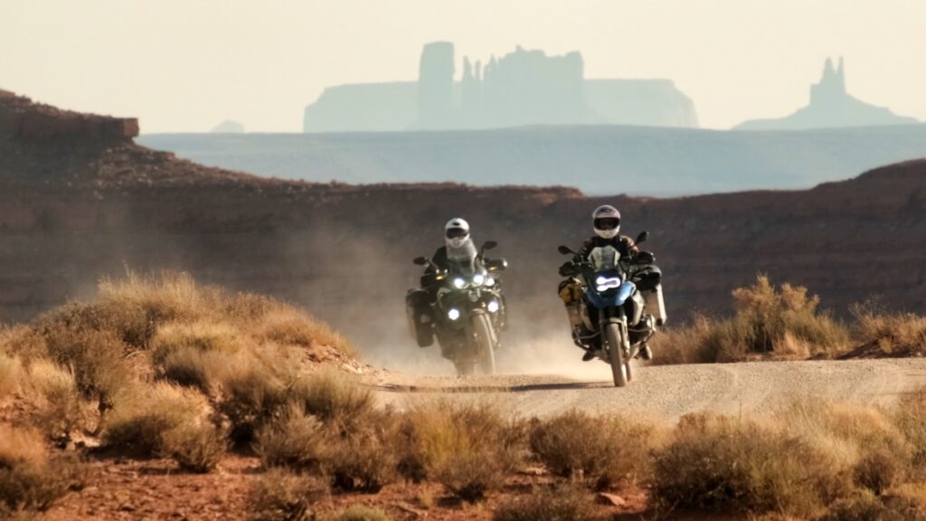 Sterling Noren and Eva Rupert motorcycle riding through Garden of the Gods in Utah