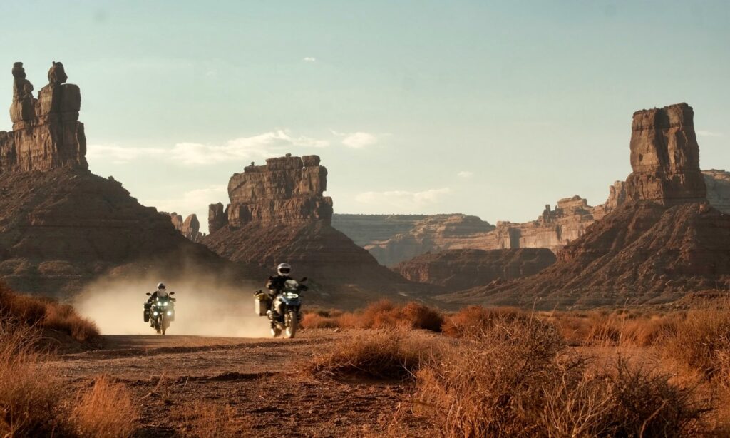 Sterling Noren and Eva Rupert motorcycle riding through Garden of the Gods in Utah
