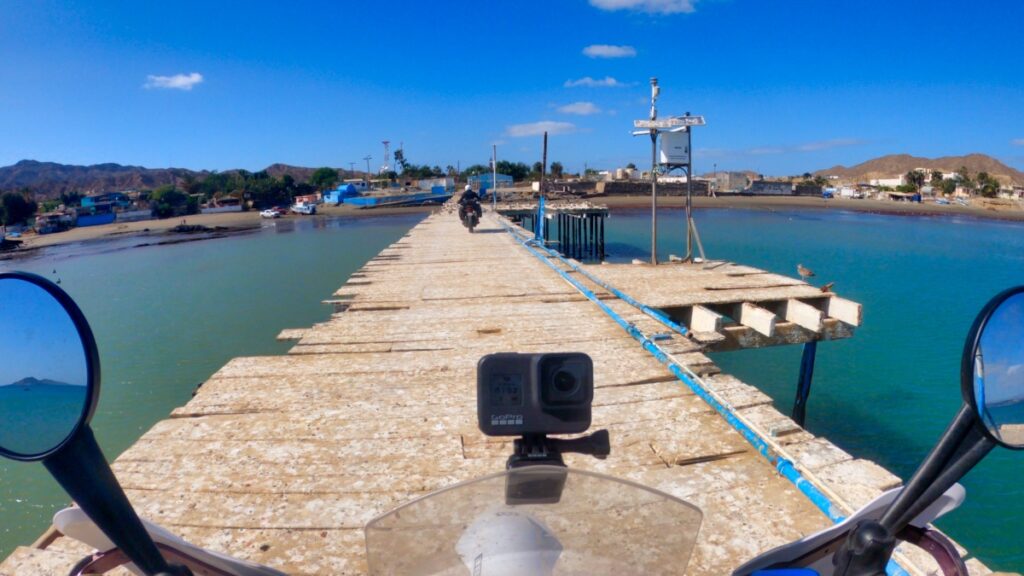 Motorcycling on old wooden pier in Bahia Tortugas Baja California