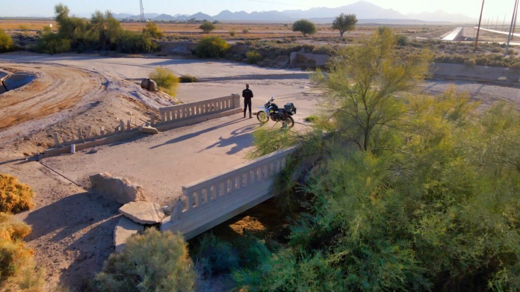 Sterling Noren and his motorcycle parked on an abandoned bright on historic US Highway 80 in Arizona