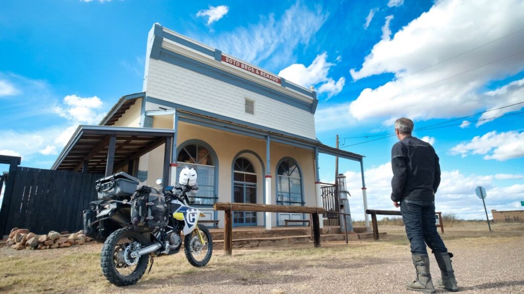 Sterling Noren and his Husqvarna motorcycle in Pearce ghost town