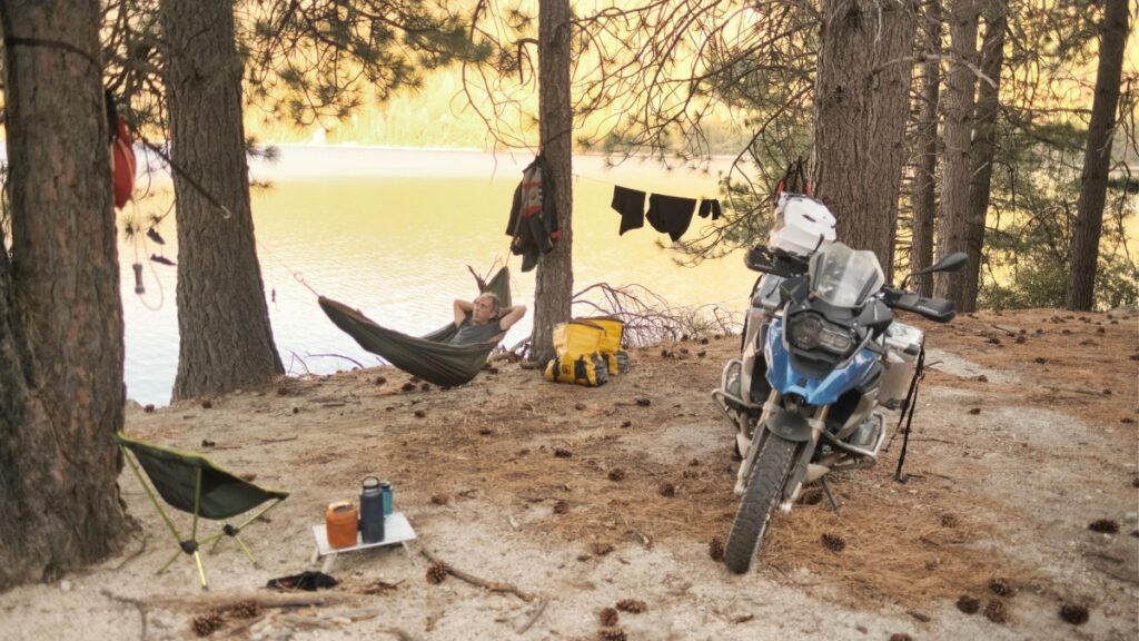 Sterling Noren motorcycle camping laying in a hammock