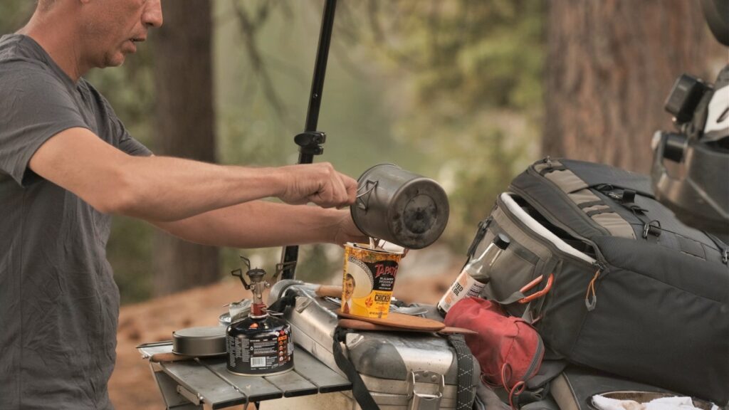 Motorcycle cooking and camping preparing soup