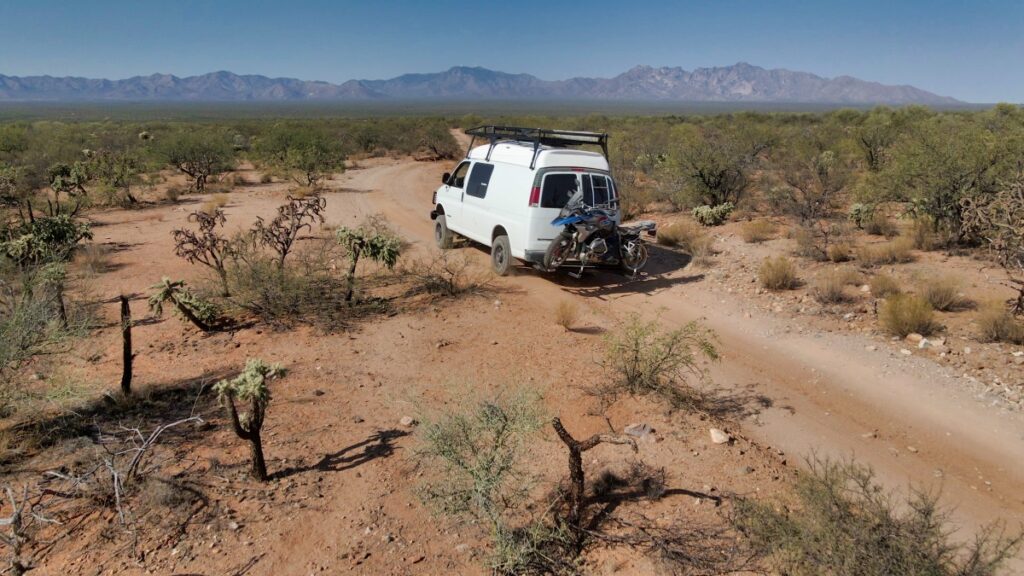 Sterling Noren driving van with motorcycle on back into Buenos Aires National Wildlife Refuge 2020