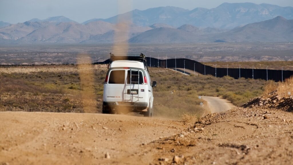 Sterling Noren Geronimo Trail 2021 van camping driving desert road by US Mexico border