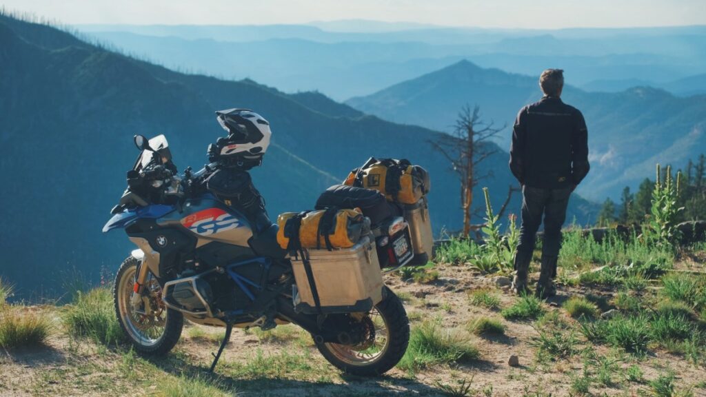 Sterling Noren and BMW GS motorcycle overlooking mountains in New Mexico
