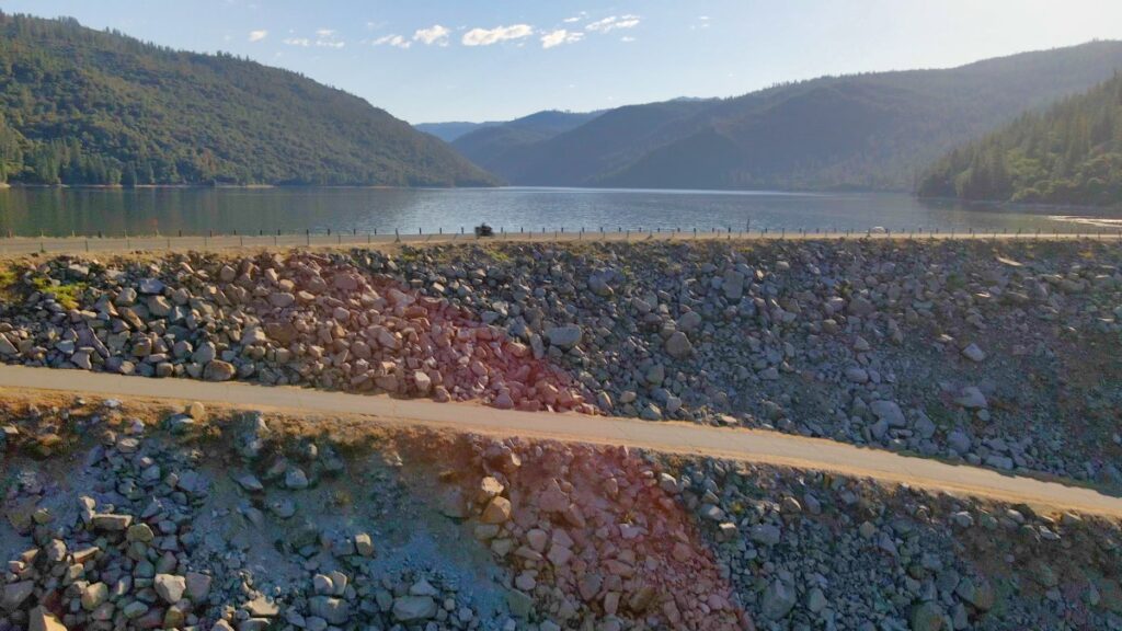 motorcycle riding over dam at Beardsley Reservoir in California