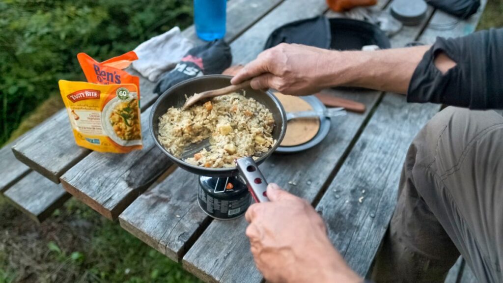 cooking dinner on camping stove