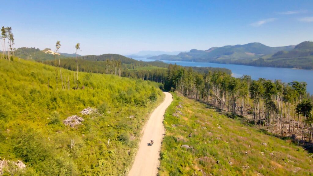 Motorcyclist Sterling Noren riding solo through clearcut forest 
in remote Vancouver Island